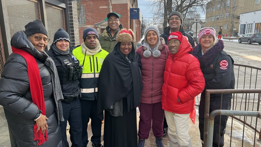 Photo of Fire Department and Chicago Police Department staff with Young Masterbuilders in Motoin volunteers event: Honk Your Horn for love in the 49th Ward on Valentine's Day.